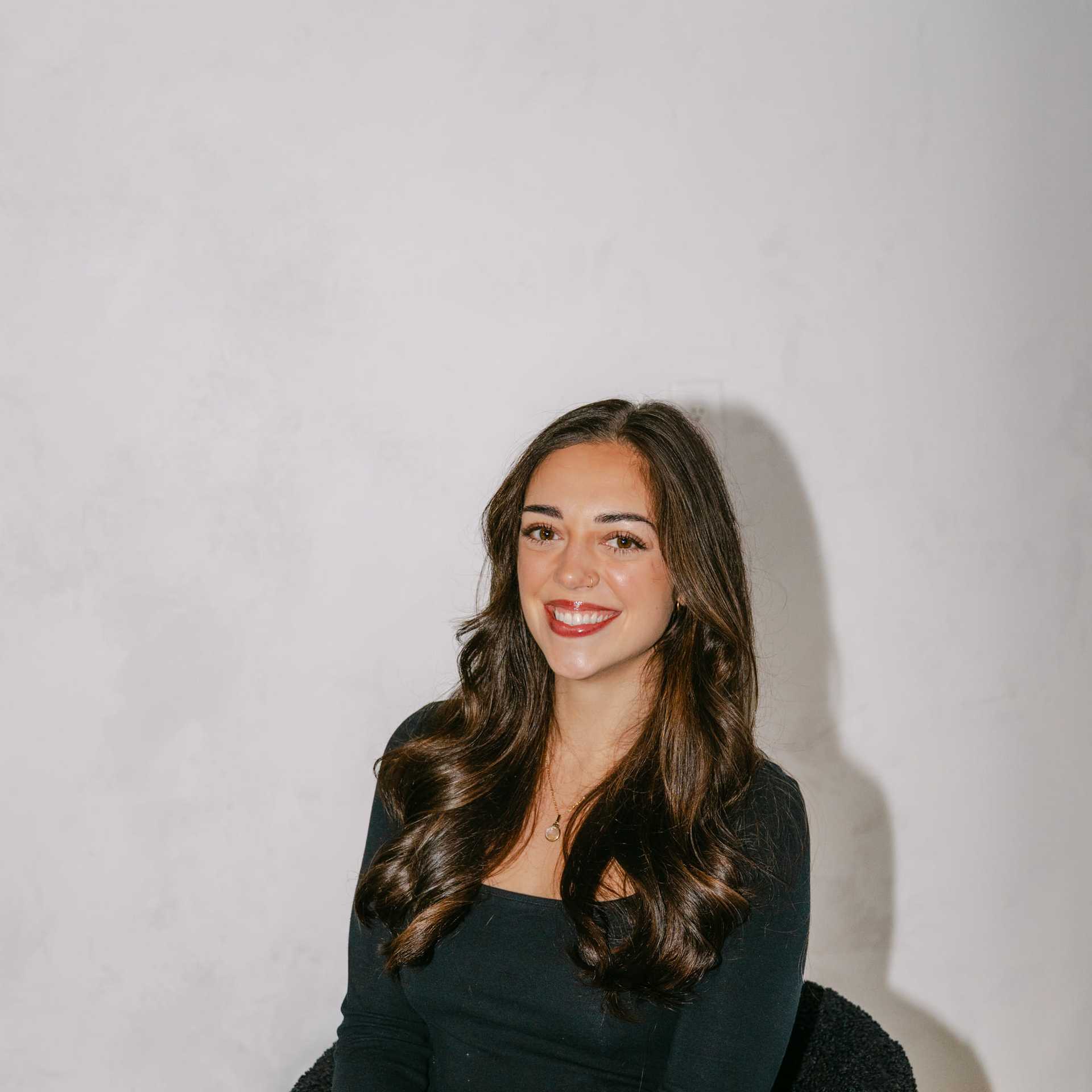 Portrait of Erin Dubots, a professional stylist at Chromatique Salon, showcasing their expertise and style.