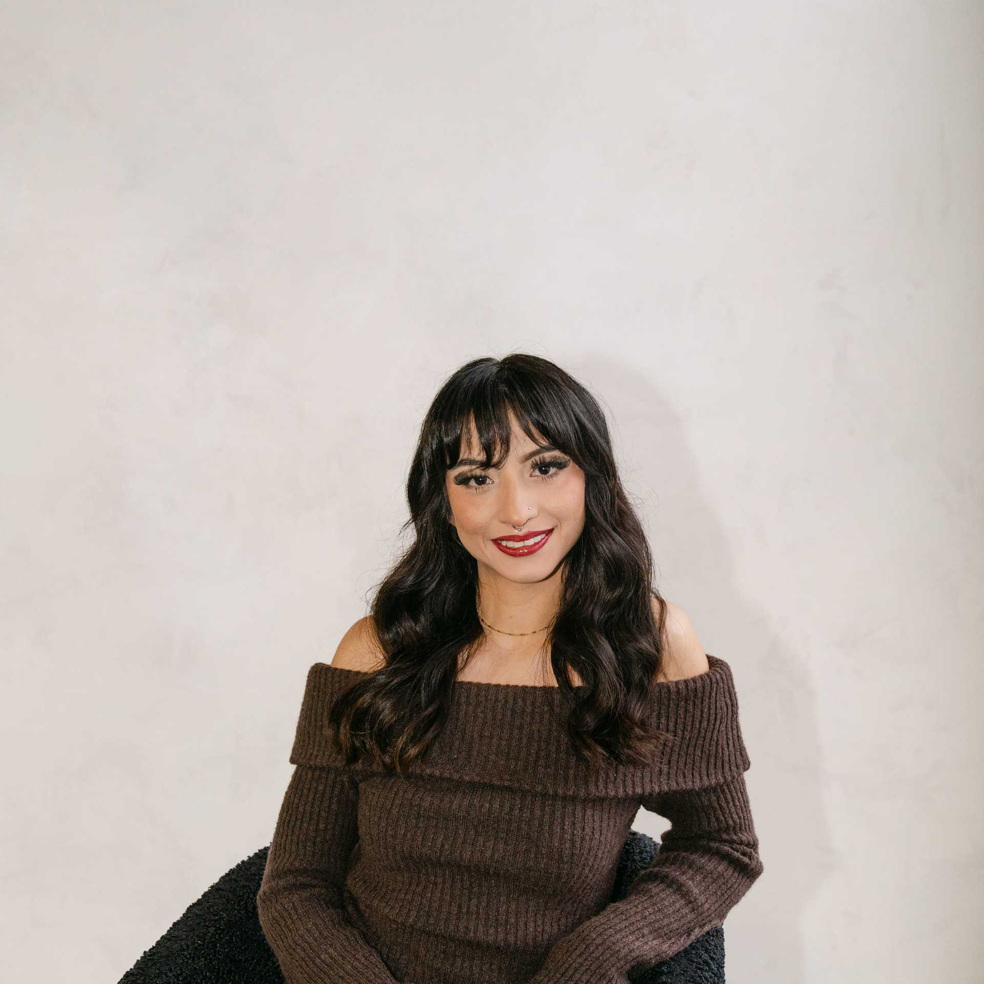 Portrait of Adriana Rodriguez, a professional stylist at Chromatique Salon, showcasing their expertise and style.