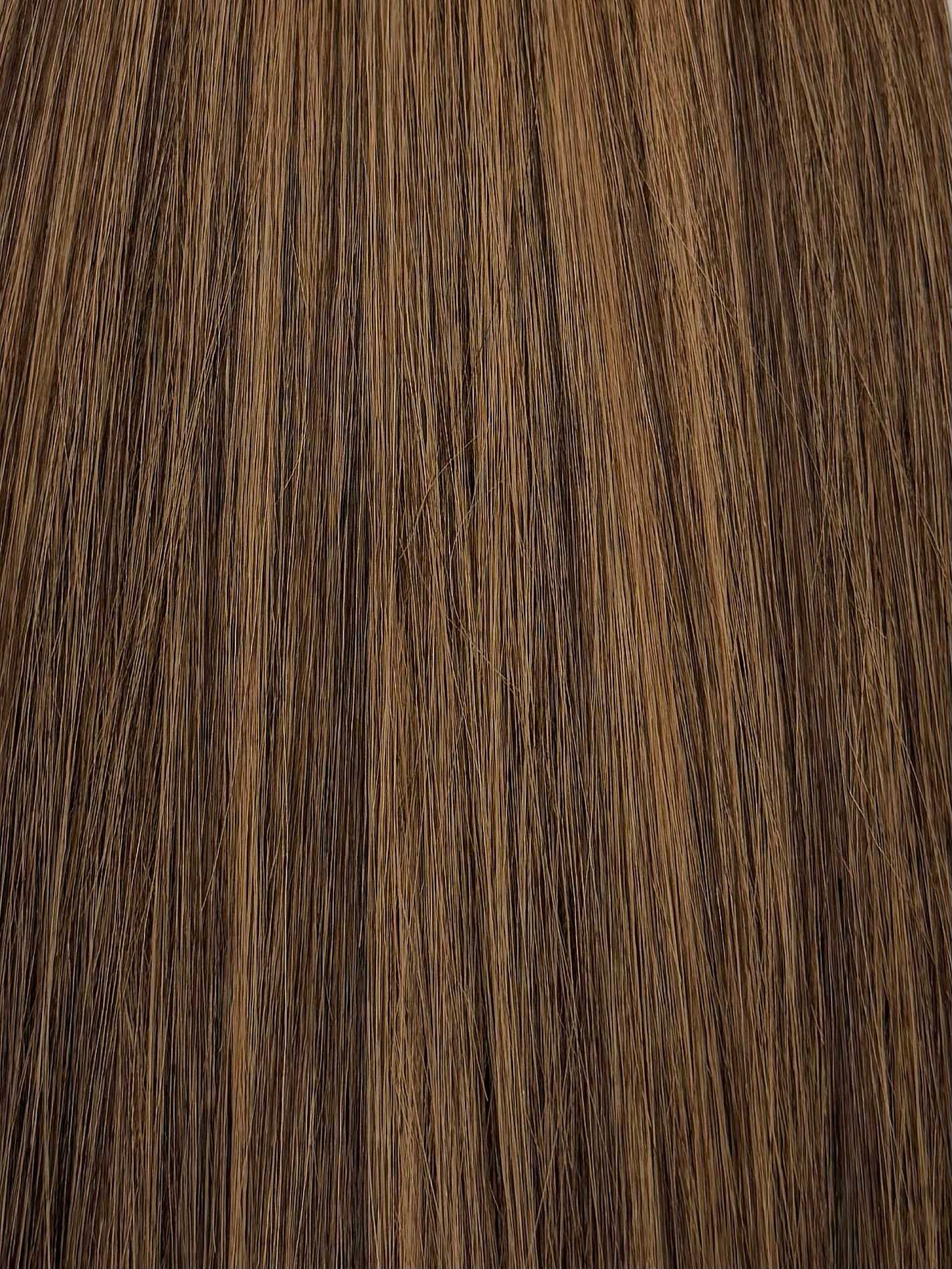 Close-up of light brown hair texture, showing smooth and straight strands.