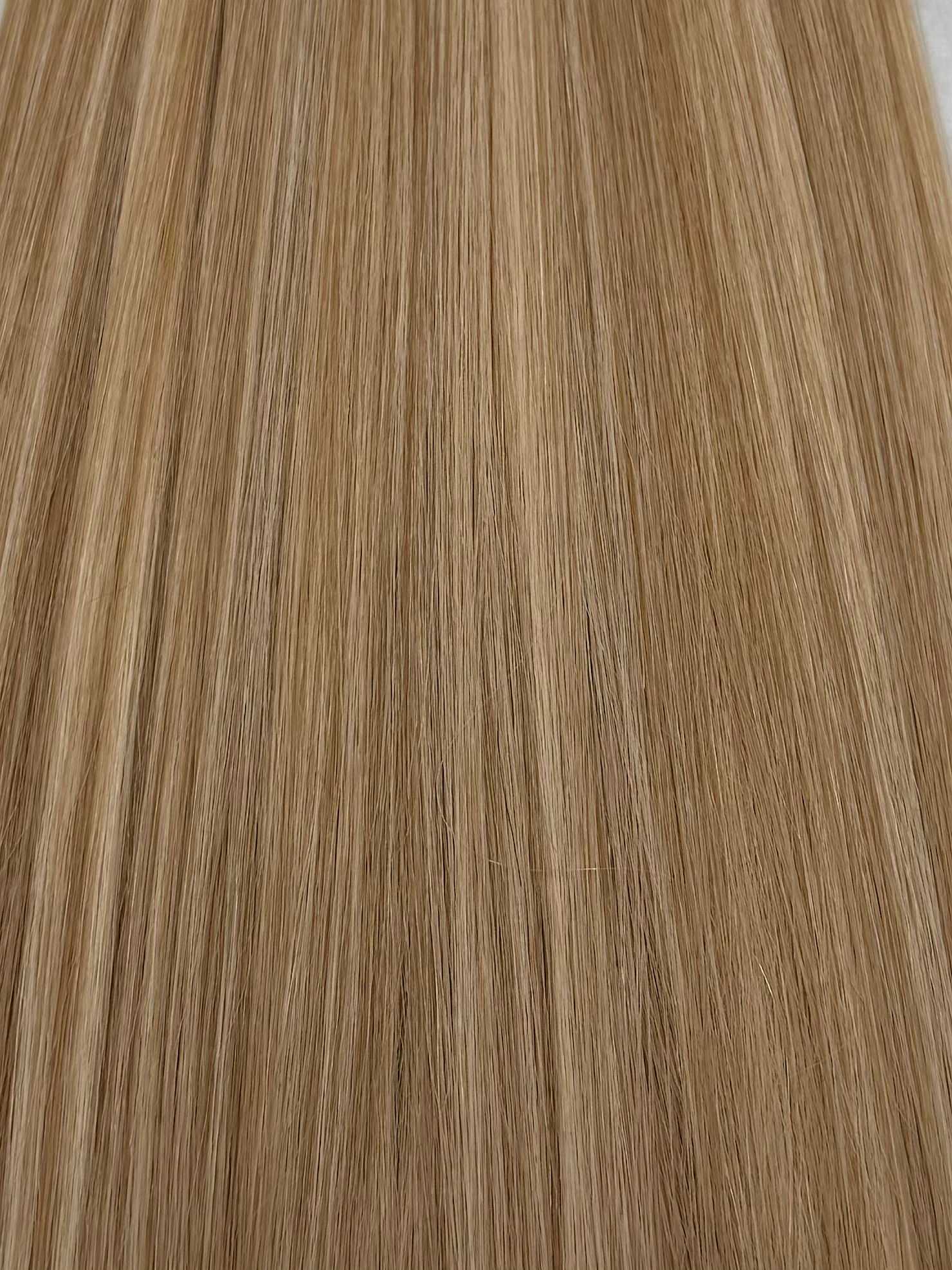 Close-up of long, straight, light brown-blonde hair strands neatly aligned.
