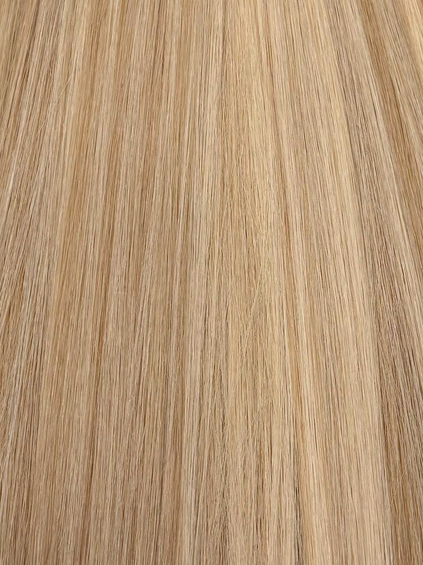 Blonde straight hair texture close-up, showing smoothness and uniformity in color and strands.